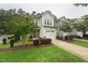 Charming two-story home with a one car garage, landscaped front yard, and inviting curb appeal at 241 White Oak Ridge Dr, Garner, NC 27529