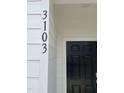 A close up of the black house number, 3103, next to a black front door at 3103 White Blossom Ct, Raleigh, NC 27610