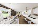 Open-concept living space with a dining area, kitchen island, and stylish furniture at 320 Beacon Dr, Pittsboro, NC 27312
