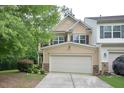 Two-story home featuring a two-car garage, neutral siding, and well-maintained landscaping at 321 Westgrove Ct, Durham, NC 27703