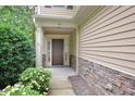 Inviting front entrance showcasing neutral siding, stone accents, and a covered porch at 321 Westgrove Ct, Durham, NC 27703