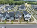 Aerial view of a neighborhood showcasing well-maintained homes, tree-lined streets, and community layout at 34 Millennium Dr, Pittsboro, NC 27312