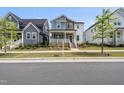 Beautiful two-story home with a combination of blue, brown, and white siding at 34 Millennium Dr, Pittsboro, NC 27312