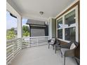Relaxing front porch with cushioned chairs and an outdoor table at 34 Millennium Dr, Pittsboro, NC 27312