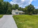 Quaint home with a spacious yard and a long driveway nestled among mature trees at 381 Gray Ghost Ln, Benson, NC 27504