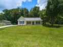 Adorable one-story home with a lush front lawn, showcasing a peaceful setting at 381 Gray Ghost Ln, Benson, NC 27504