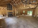 A look at the unfinished living room with exposed framing and beams, ready for customization at 4024 N Nc 581 Hwy, Kenly, NC 27542