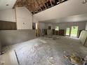 Spacious living room during construction, showcasing high ceilings, exposed framing, and natural light at 4024 N Nc 581 Hwy, Kenly, NC 27542