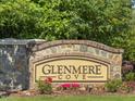 Elegant stone community sign for Glenmere Cove with lush landscaping and bright flowers at 427 Cedar Pond Ct, Knightdale, NC 27545