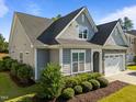 Gray shake shingle home with landscaped garden and a two-car garage at 427 Cedar Pond Ct, Knightdale, NC 27545