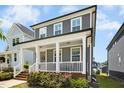 Two-story home featuring a covered porch, white columns and an inviting facade at 513 Basin Hill Dr, Wake Forest, NC 27587