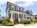 Beautiful two-story home with a covered porch and manicured landscaping at 513 Basin Hill Dr, Wake Forest, NC 27587