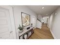 Welcoming entryway with hardwood floors, stylish console table, decorative artwork, and neutral tones at 528 Folk Song Way, Wendell, NC 27591