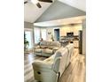 Spacious living room flowing into kitchen with stainless appliances and granite countertops at 55 Running Deer Path, Timberlake, NC 27583