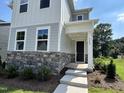 Charming two-story home with stone accents and a welcoming front porch at 5649 Cayden Cove Dr, Wendell, NC 27591