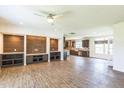 Open concept living space featuring wood-look tile floors and a custom wood accent wall at 589 Atkinson Mill Rd, Selma, NC 27576
