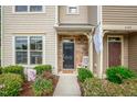 Inviting front porch with stone detail, lovely landscaping, and a cozy rocking chair at 6301 Pesta Ct, Raleigh, NC 27612