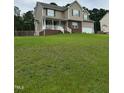 Charming two-story home with neutral siding, green shutters, and a well maintained lawn at 642 Pinevalley Ln, Sanford, NC 27332