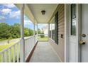 View of a cozy porch with white railing and siding, creating a welcoming entrance to the home at 642 Pinevalley Ln, Sanford, NC 27332