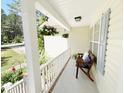 Cozy porch setting with decorative pillows, hanging flowers, and a welcoming view at 65 Shorrey Pl, Youngsville, NC 27596