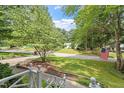 Charming home nestled on a lush corner lot, complete with an American flag, beautiful landscaping, and mature trees at 7209 St Ledger Dr, Raleigh, NC 27613