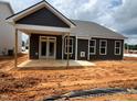 The backyard features a covered patio, complementing the home's exterior with a seamless blend of indoor-outdoor living at 798 Old Station Pointe, Angier, NC 27501