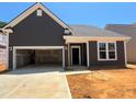 Charming home featuring a two-car garage, complementary landscaping, and craftsman style architecture at 798 Old Station Pointe, Angier, NC 27501