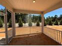 A screened in porch featuring exterior views of the homes landscaping at 798 Old Station Pointe, Angier, NC 27501