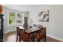 Bright dining room with modern decor, a large window, and a spacious wooden table at 9120 Dupree Meadow Dr, Angier, NC 27501