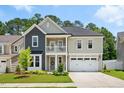 Charming two-story home with a welcoming front porch, beautiful landscaping, and a two-car garage at 9120 Dupree Meadow Dr, Angier, NC 27501