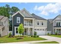 Charming two-story home with a welcoming front porch, beautiful landscaping, and a two-car garage at 9120 Dupree Meadow Dr, Angier, NC 27501