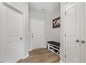 Inviting entryway with hardwood floors, a bench, and ample storage space at 100 Arrowtown Way, Kenly, NC 27542