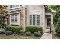 Detailed view of the townhouse exterior highlighting the stone accents and front door at 100 Tobacco Leaf Ln, Apex, NC 27502