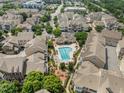 Aerial view of community showcasing a pool, fire pit, and well-maintained green spaces and housing at 10310 Sablewood Dr # 211, Raleigh, NC 27617