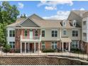 Attractive multi-story townhome with brick facade, second-floor balcony, and manicured landscaping at 10310 Sablewood Dr # 211, Raleigh, NC 27617