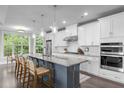Bright, modern kitchen features stainless appliances, granite countertops, and a spacious center island with bar seating at 10310 Sablewood Dr # 211, Raleigh, NC 27617