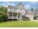 Charming two-story home with a front porch, attached two-car garage, and a well-manicured lawn at 105 Acorn Ridge Ln, Holly Springs, NC 27540