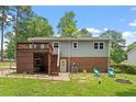 Backyard view showcasing a deck, brick patio, and stairs leading to a grassy yard at 105 Otter Dr, Cary, NC 27513