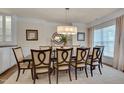 Formal dining room featuring a large table with seating for eight and a stylish chandelier at 1120 Hooper Pl, Durham, NC 27703