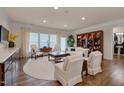 Sun-lit living room features hardwood floors, recessed lighting, and a beautiful built-in bookcase at 1120 Hooper Pl, Durham, NC 27703