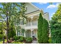 Two-story home has a covered porch, lush landscaping, a sidewalk, and a welcoming entrance at 1201 Somers Dr, Morrisville, NC 27560