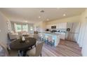 Open concept living area with kitchen, dining space, and living room with modern finishes and neutral tones at 1213 Solace Way, Rolesville, NC 27571