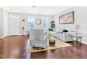 Bright living room with hardwood floors, a white couch, and large windows at 1312 Regulator St, Raleigh, NC 27603