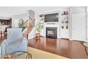 Living room with a fireplace, built-in shelves, and hardwood flooring at 1312 Regulator St, Raleigh, NC 27603