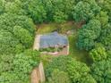 Stunning aerial view of estate nestled among mature trees, showcasing landscaped grounds and privacy at 1317 Woodgate Manor Ct, Raleigh, NC 27614