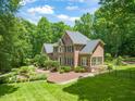 Spacious home with landscaped yard, a fenced backyard, and a picturesque setting surrounded by mature trees at 1317 Woodgate Manor Ct, Raleigh, NC 27614
