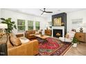 Bright living room with natural light, hardwood floors, fireplace and neutral tones creating a comfortable ambiance at 137 Azalea View Way, Holly Springs, NC 27540