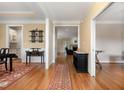 Hallway features hardwood floors and neutral walls, seamlessly connecting various living spaces at 142 Crestline Dr, Selma, NC 27576