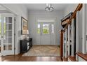 Welcoming foyer with hardwood floors, elegant lighting, and staircase at 1508 Heritage Reserve Ct, Wake Forest, NC 27587