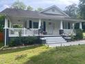 Inviting front porch with white railings and a welcoming entrance at 2037 Swepsonville Rd, Graham, NC 27253